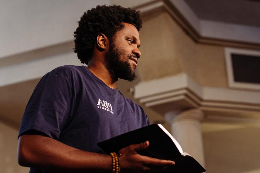 PBA student holds a bible in chapel.